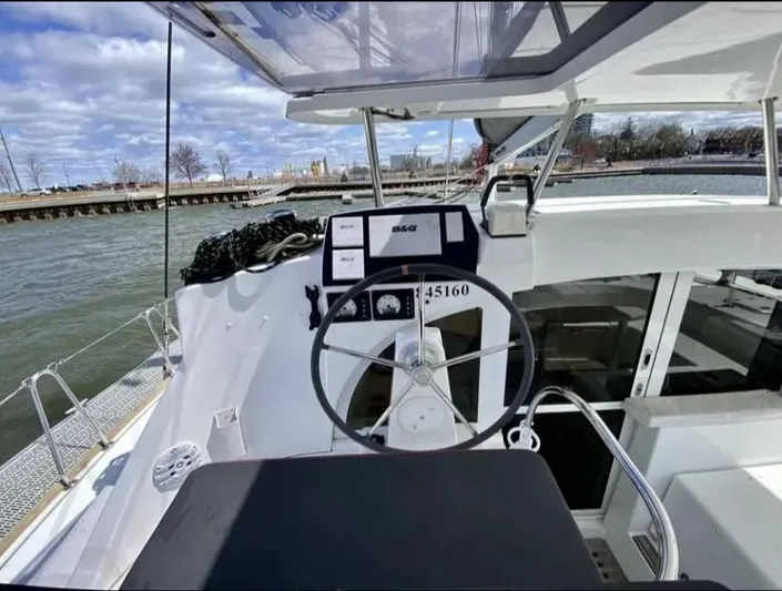Blue Mind Yacht Photos Pics Cockpit of 2018 Lagoon 380 S2 catamaran with steering wheel and navigation equipment.