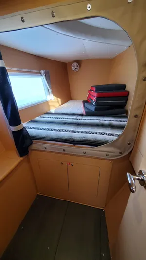 Blue Mind Yacht Photos Pics Cozy cabin interior of 2018 Lagoon 380 S2 catamaran with bed and window.