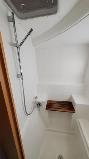 Blue Mind Yacht Photos Pics Shower area in 2018 Lagoon 380 S2 yacht with wooden bench and modern fixtures.