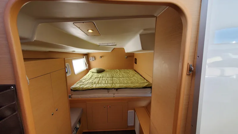 Blue Mind Yacht Photos Pics Interior cabin of 2018 Lagoon 380 S2 catamaran with bed and wooden finish.