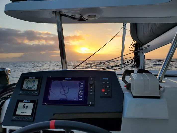 Blue Mind Yacht Photos Pics Lagoon 380 S2 yacht cockpit with navigation system at sunset, 2018 model.