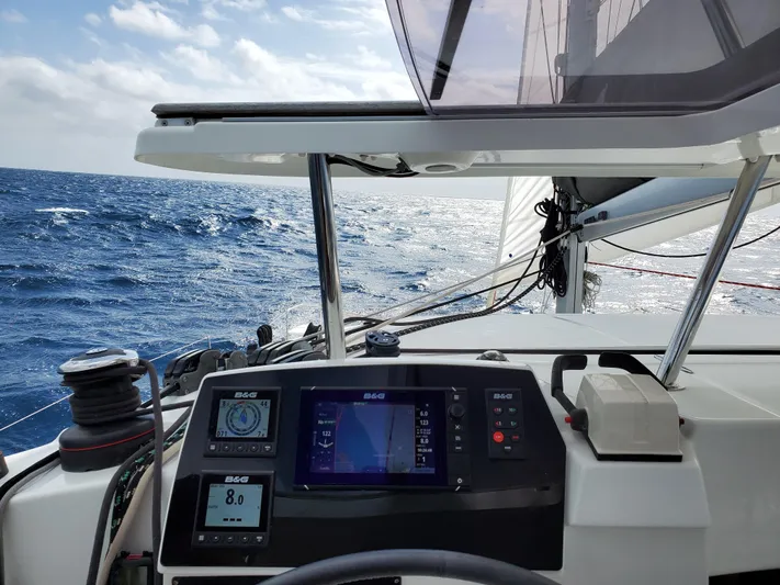 Blue Mind Yacht Photos Pics Cockpit view of 2018 Lagoon 380 S2 sailing on open sea with navigation instruments.