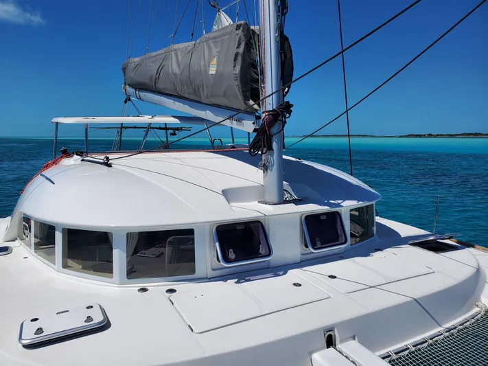 Blue Mind Yacht Photos Pics 2018 Lagoon 380 S2 catamaran sailing on clear blue waters under a sunny sky.
