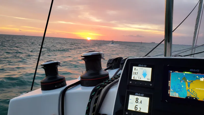 Blue Mind Yacht Photos Pics Lagoon 380 S2 sailing at sunset, featuring navigation instruments, 2018 model.