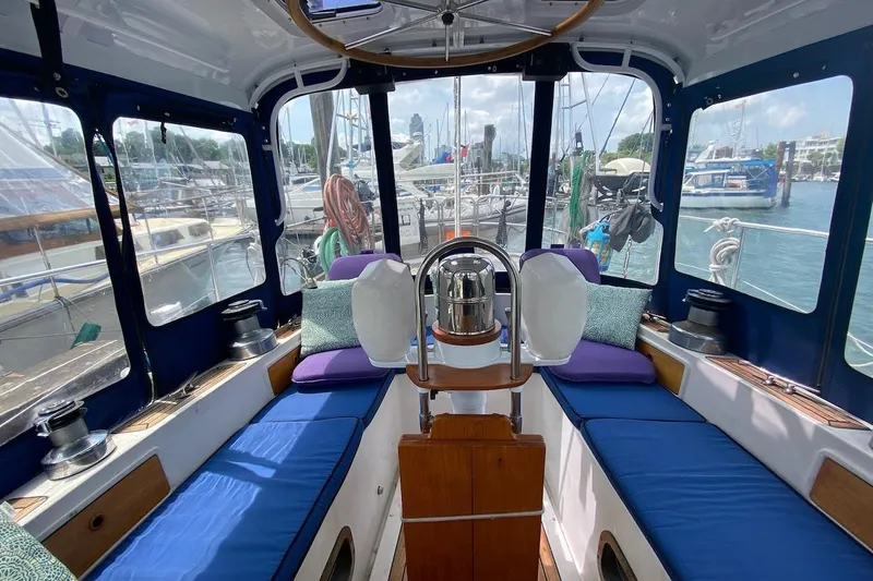 Ganache II Yacht Photos Pics Interior of 1985 Liberty 458 yacht with blue seating and marina view.