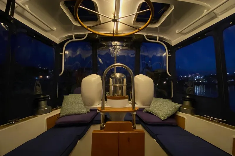 Ganache II Yacht Photos Pics Interior of 1985 Liberty 458 yacht with cozy seating and ambient lighting at night.