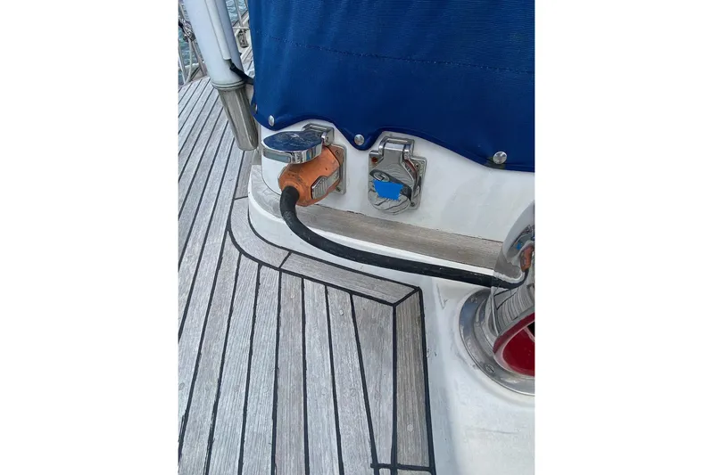 Ganache II Yacht Photos Pics Power connection on 1985 Liberty 458 boat deck with blue cover.