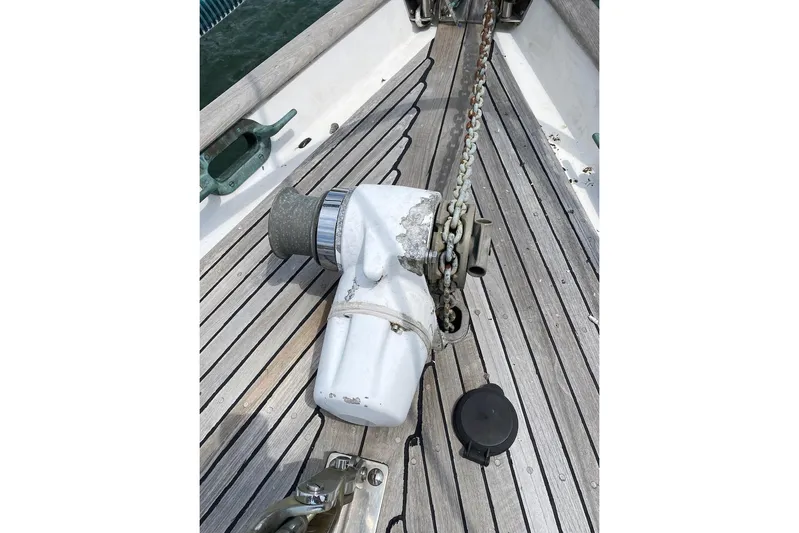 Ganache II Yacht Photos Pics Anchor windlass on 1985 Liberty 458 sailboat deck with wooden planks.