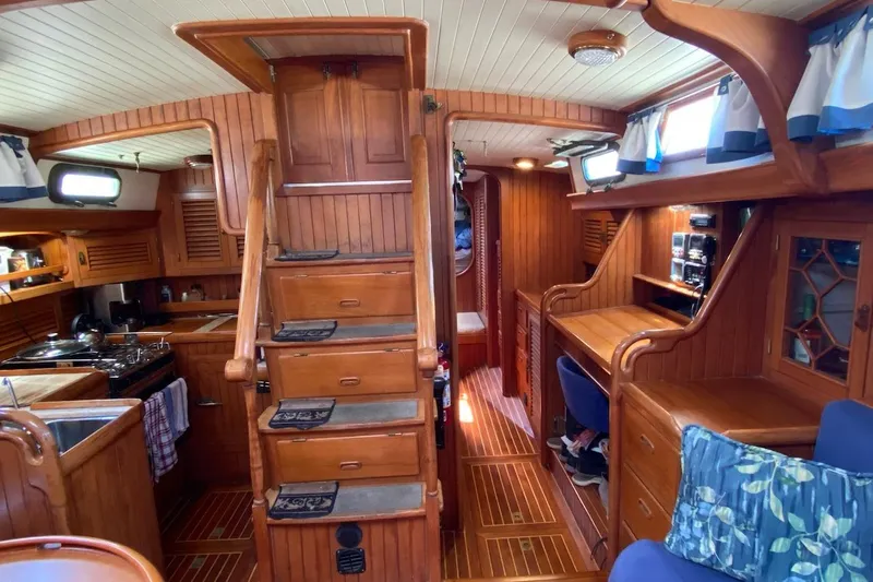 Ganache II Yacht Photos Pics Interior of 1985 Liberty 458 yacht with wooden furnishings and cozy seating area.