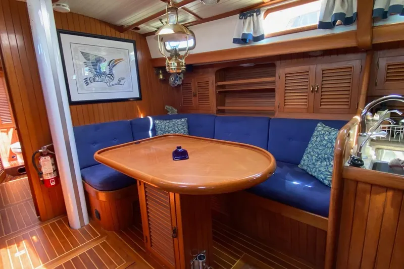 Ganache II Yacht Photos Pics Cozy 1985 Liberty 458 yacht interior with wooden decor and blue seating.