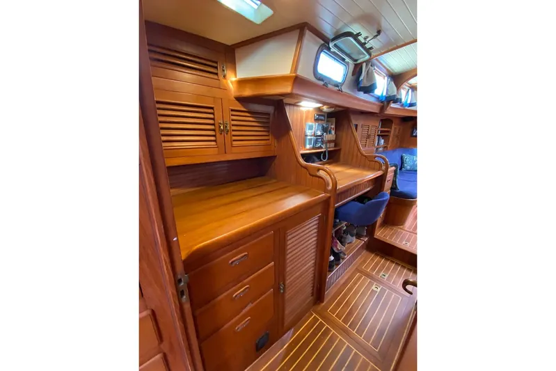 Ganache II Yacht Photos Pics Luxurious wooden interior of 1985 Liberty 458 yacht, featuring elegant cabinetry and seating.