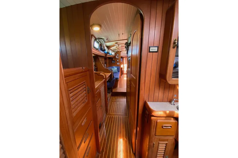 Ganache II Yacht Photos Pics Interior of 1985 Liberty 458 yacht with wooden paneling and cozy cabin layout.