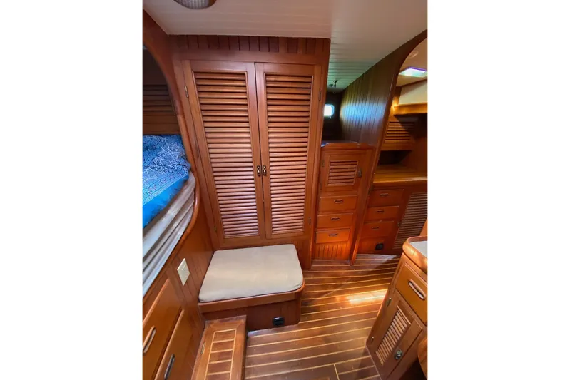 Ganache II Yacht Photos Pics 1985 Liberty 458 yacht interior with wooden cabinetry and cozy seating area.