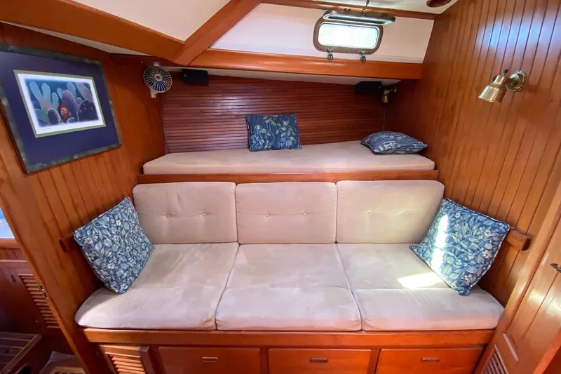 Ganache II Yacht Photos Pics Cozy 1985 Liberty 458 yacht interior with wooden paneling and cushioned seating.