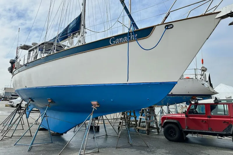 Ganache II Yacht Photos Pics Sailboat "Ganache" on stands, Liberty 458 model, 1985, with red vehicle nearby.