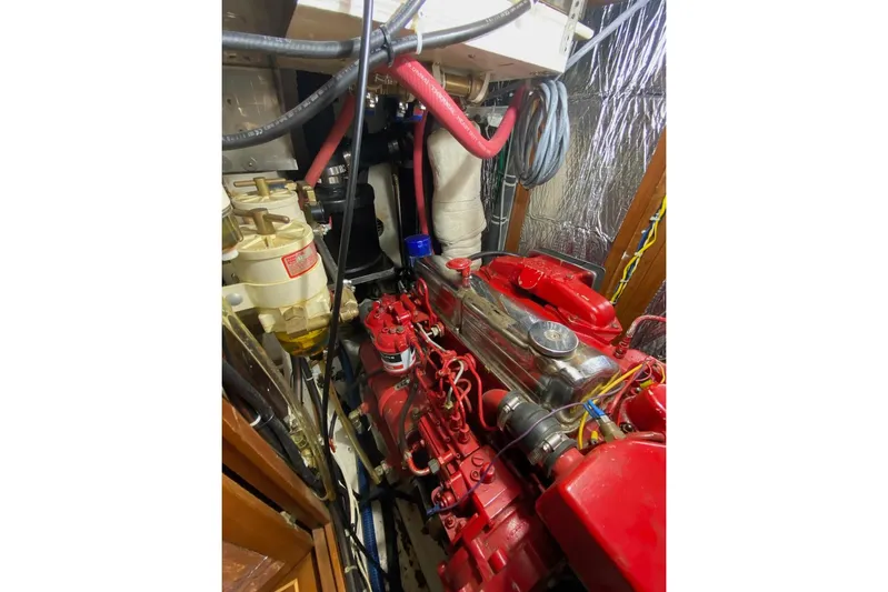 Ganache II Yacht Photos Pics Engine room of 1985 Liberty 458 with red engine components and wiring.