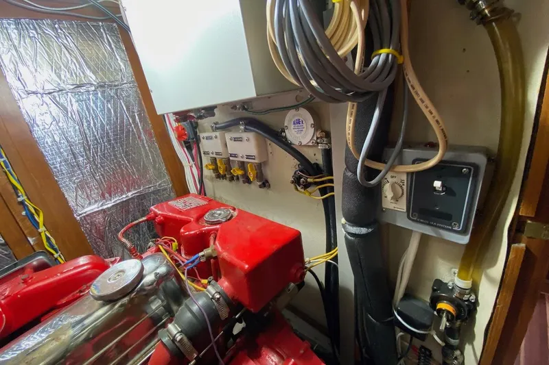 Ganache II Yacht Photos Pics Engine room of 1985 Liberty 458 with red machinery and wiring.
