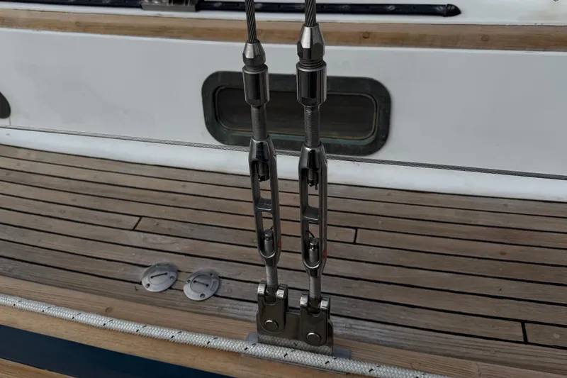 Ganache II Yacht Photos Pics Stainless steel rigging on 1985 Liberty 458 sailboat deck with wooden planks.