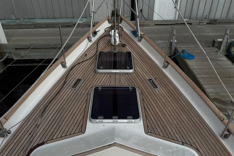 Ganache II Yacht Photos Pics Deck of 1985 Liberty 458 yacht with wooden finish and hatches, docked at marina.