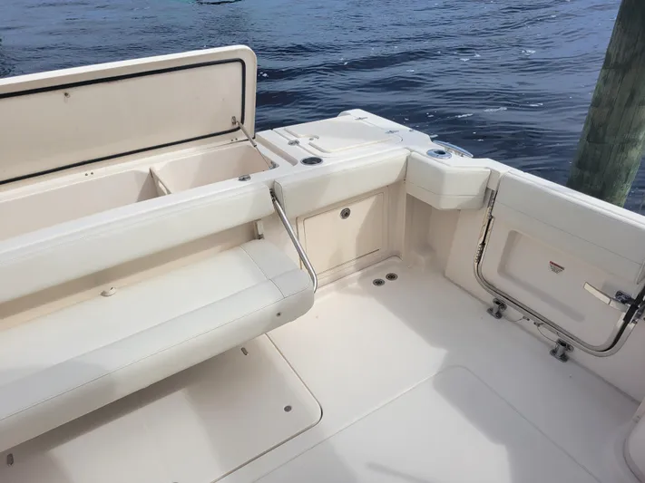  Yacht Photos Pics 2022 Grady-White Express 370 boat interior with seating and storage, docked by water.