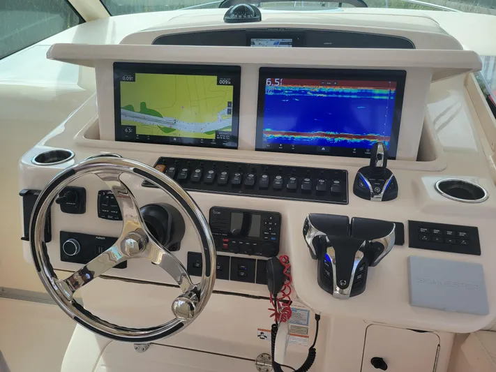  Yacht Photos Pics 2022 Grady-White Express 370 helm with dual navigation screens and modern controls.