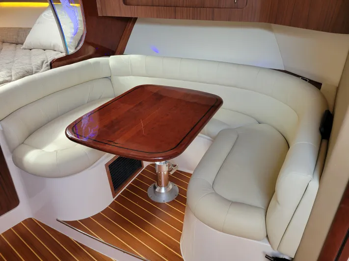  Yacht Photos Pics Luxurious interior of 2022 Grady-White Express 370 with elegant seating and wooden table.