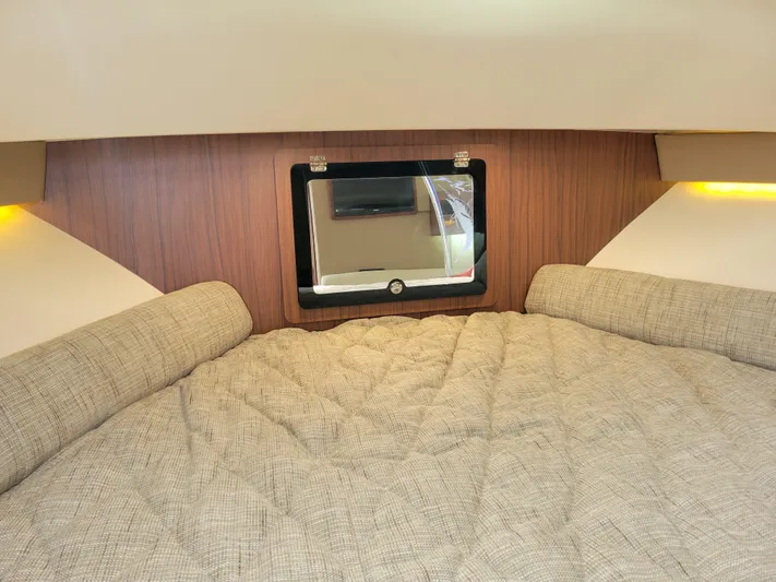  Yacht Photos Pics 2022 Grady-White Express 370 cabin interior with cozy bedding and window.