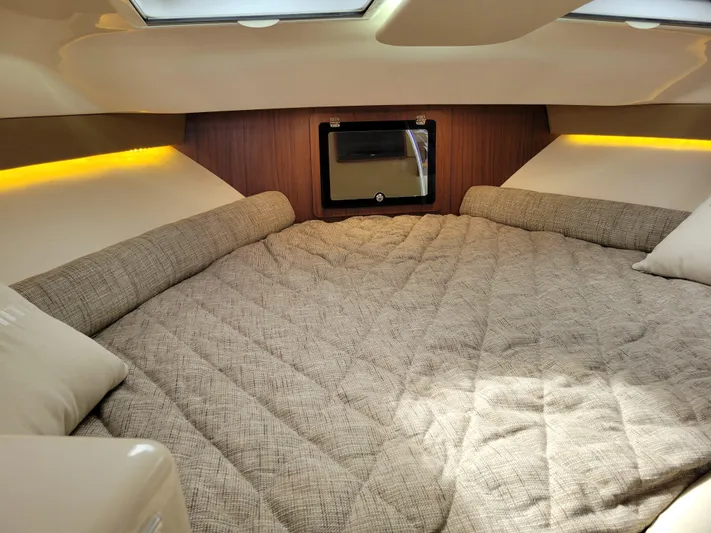  Yacht Photos Pics 2022 Grady-White Express 370 cabin interior with cozy bed and ambient lighting.