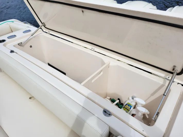  Yacht Photos Pics Open storage compartment on 2022 Grady-White Express 370 boat, featuring cleaning supplies.