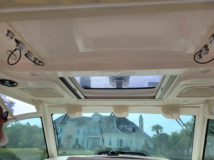  Yacht Photos Pics Interior view of 2022 Grady-White Express 370 boat with sunroof and scenic background.