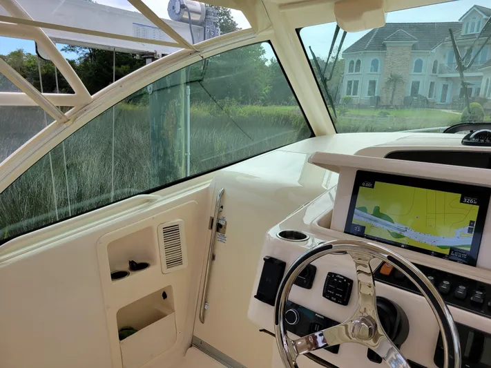  Yacht Photos Pics 2022 Grady-White Express 370 helm with navigation display and steering wheel.