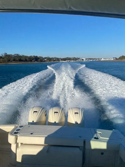  Yacht Photos Pics 2022 Grady-White Express 370 boat cruising, leaving a wake on a sunny day.