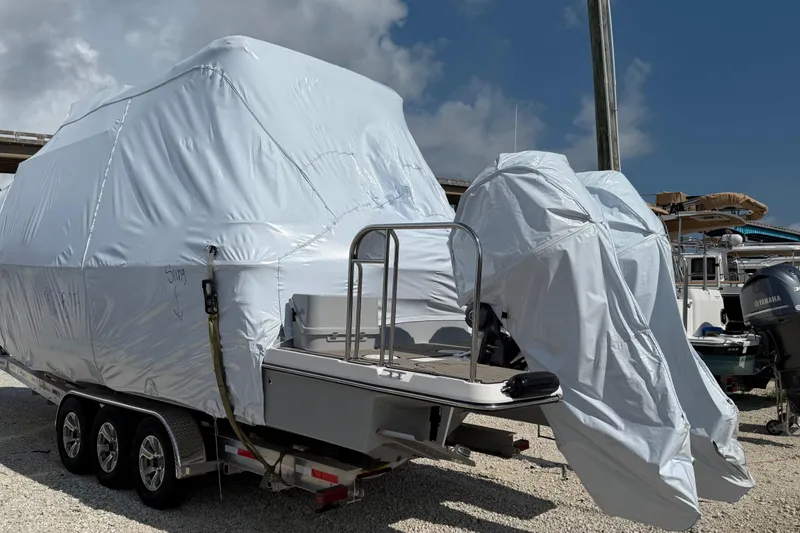  Yacht Photos Pics 2025 Cutwater C-32 CB boat covered in protective wrap on a trailer.