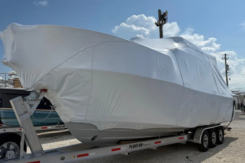  Yacht Photos Pics 2025 Cutwater C-32 CB boat wrapped in protective cover on trailer.