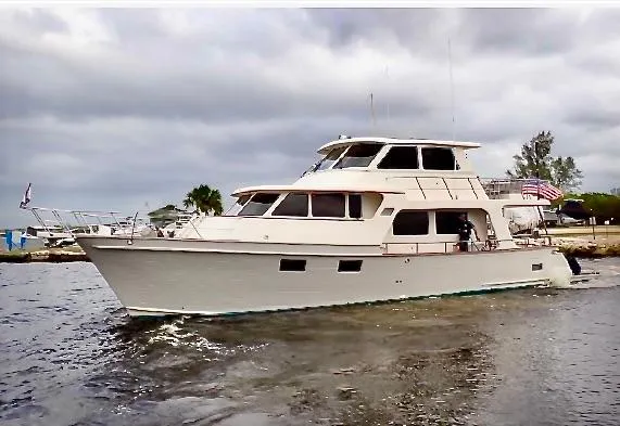 Forever Fun Yacht Photos Pics 2018 Marlow 53E CB yacht cruising on a cloudy day near the shore.
