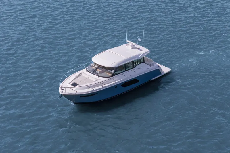 Seeker Yacht Photos Pics 2023 Tiara Yachts C49 Coupe cruising on open water, showcasing sleek design and luxury.