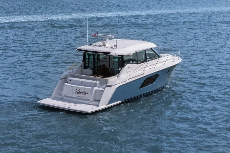 Seeker Yacht Photos Pics 2023 Tiara Yachts C49 Coupe cruising on open water.