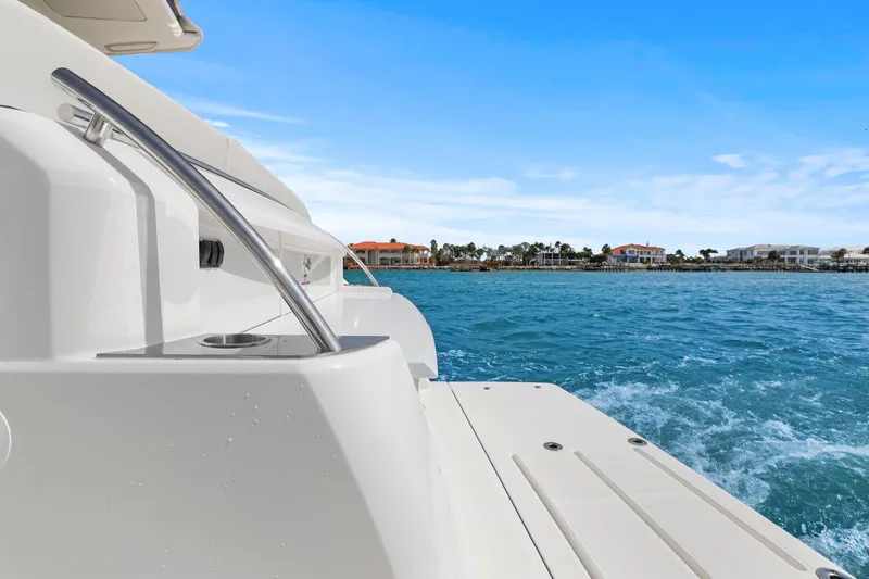 Seeker Yacht Photos Pics 2023 Tiara Yachts C49 Coupe on blue water with coastal view.