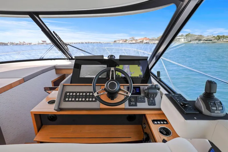 Seeker Yacht Photos Pics 2023 Tiara Yachts C49 Coupe helm with advanced navigation systems and scenic ocean view.
