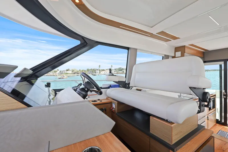 Seeker Yacht Photos Pics 2023 Tiara Yachts C49 Coupe interior with modern helm and panoramic windows.