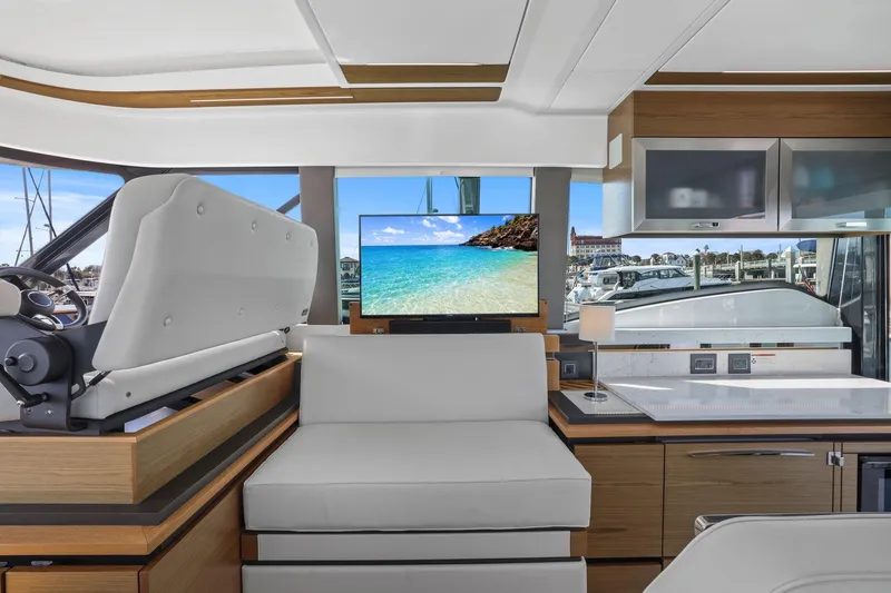 Seeker Yacht Photos Pics Luxurious interior of 2023 Tiara Yachts C49 Coupe with modern seating and scenic view.