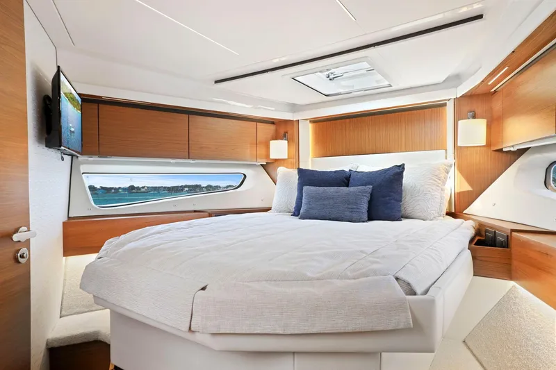Seeker Yacht Photos Pics Luxurious bedroom interior of 2023 Tiara Yachts C49 Coupe with modern design and natural light.