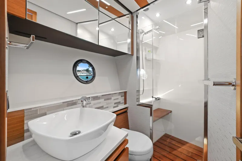 Seeker Yacht Photos Pics Luxurious bathroom in 2023 Tiara Yachts C49 Coupe with modern fixtures and elegant design.