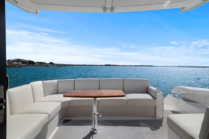 Seeker Yacht Photos Pics 2023 Tiara Yachts C49 Coupe, elegant seating area with ocean view.