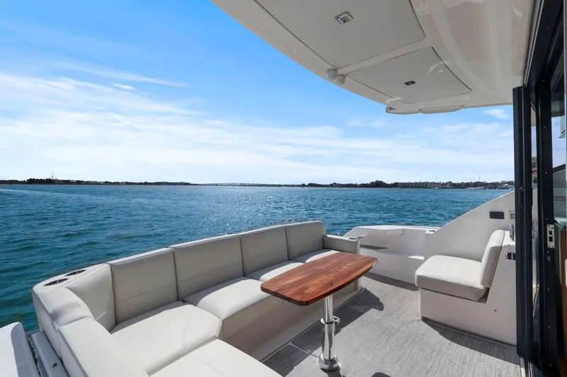 Seeker Yacht Photos Pics 2023 Tiara Yachts C49 Coupe deck with seating and ocean view.