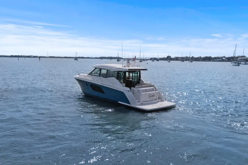 Seeker Yacht Photos Pics 2023 Tiara Yachts C49 Coupe cruising on a sunny day in open waters.