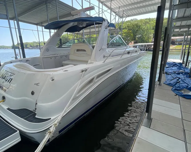 Let's Get Nauti Yacht Photos Pics 2000 Sea Ray 410 Sundancer docked in a covered marina, showcasing sleek design and spacious deck.