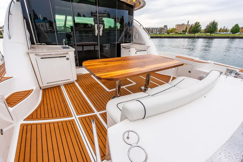  Yacht Photos Pics Luxurious 2008 Sea Ray 60 Sundancer yacht deck with elegant wood table and seating.