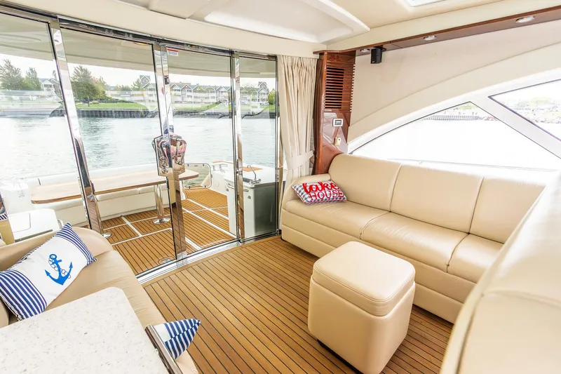  Yacht Photos Pics Luxurious interior of 2008 Sea Ray 60 Sundancer yacht with leather seating and nautical decor.
