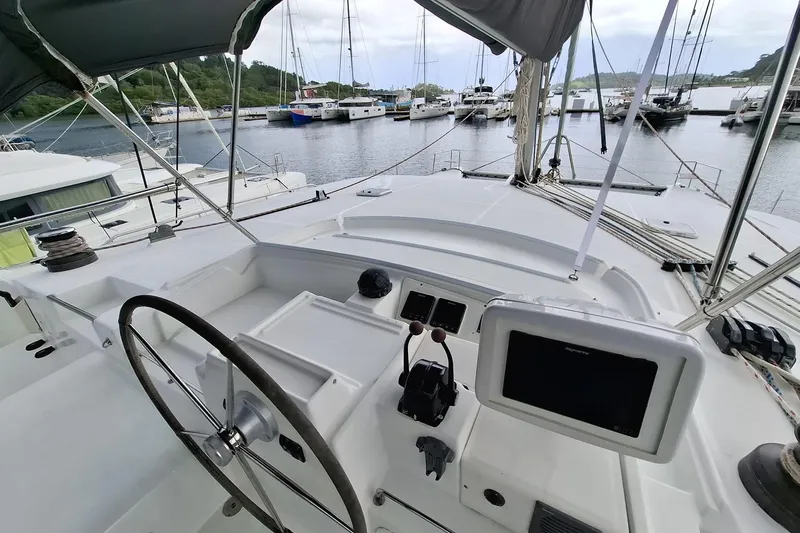  Yacht Photos Pics Cockpit view of a 2010 Lagoon 500 catamaran docked in a marina.